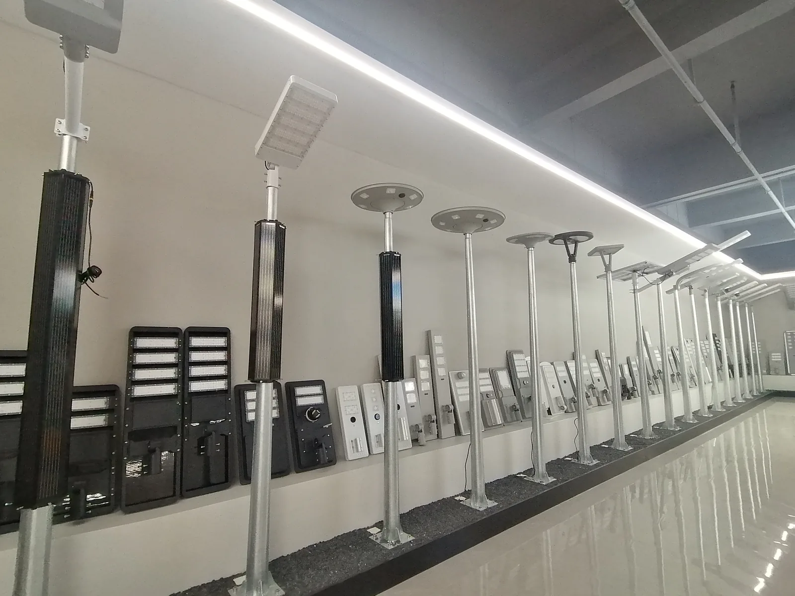 Showroom display of black all-in-one lights and solar garden pillar heads on poles