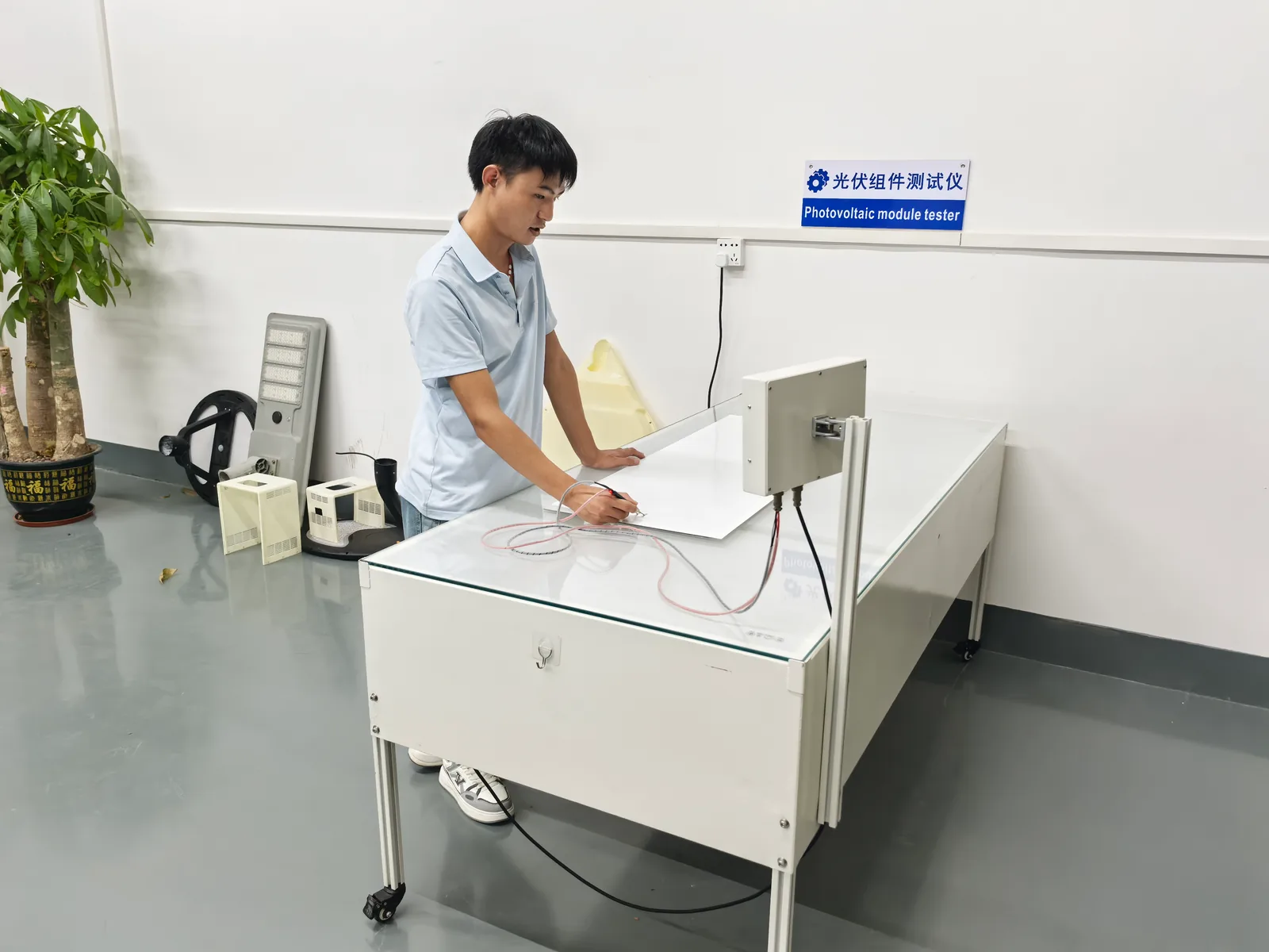 Technician testing a solar cell batch on the photovoltaic module tester