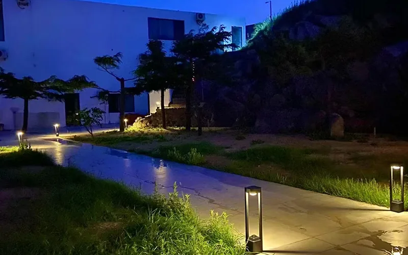 Solar garden bollard lights along a resort pathway at night